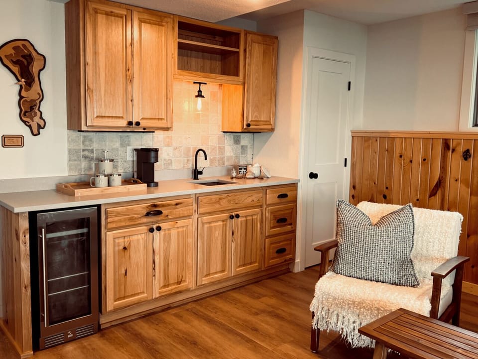 Coffee area in bedroom 2 with coffee machine, sink, beverage fridge.