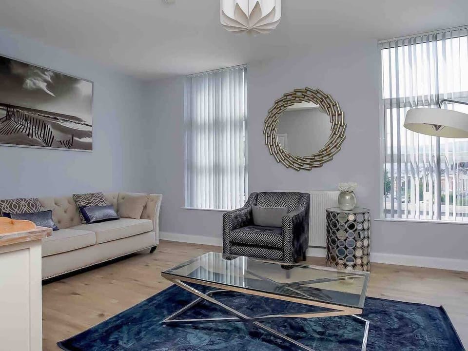 Spacious living area where all the guests can relax together. A relaxing space furnished with comfortable but stylish pieces accompanied by a smart tv,  perfect for some down time together. 