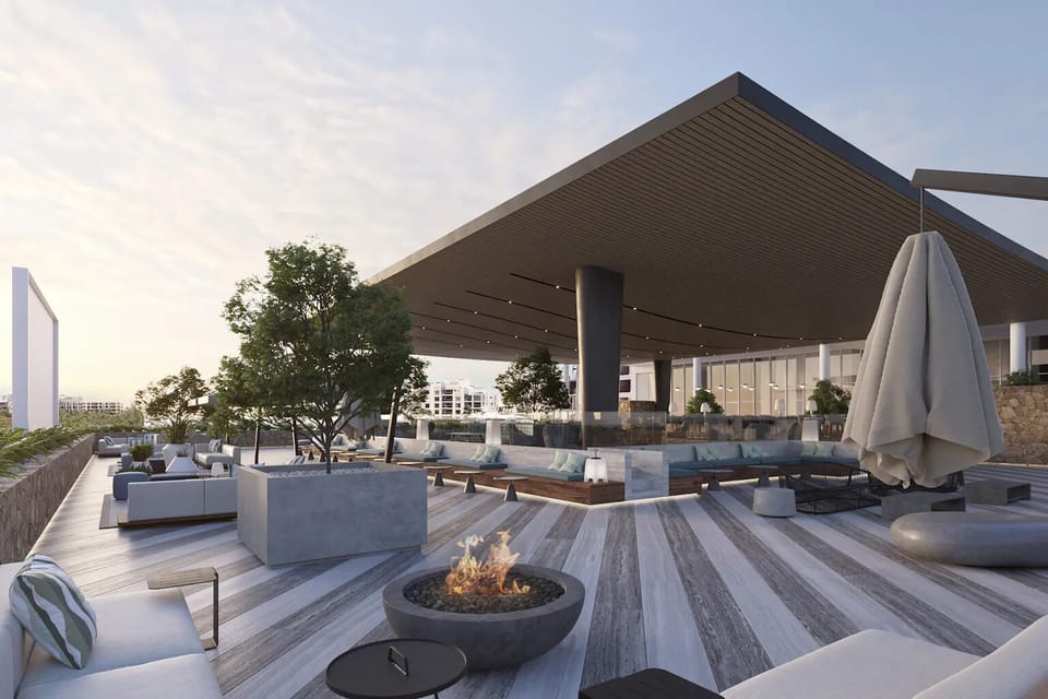 Relax on a breezy terrace with modern loungers and firepit.