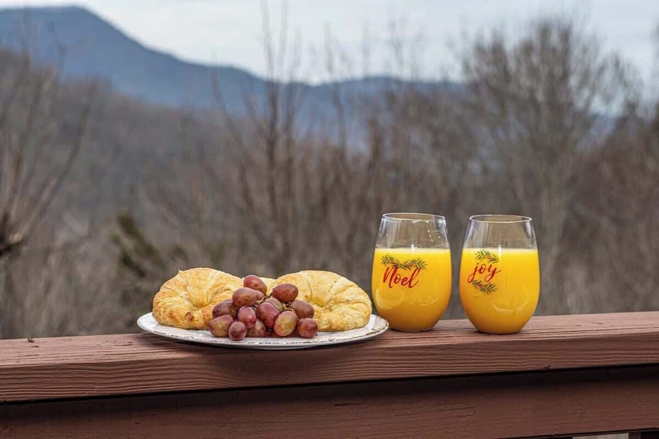 Breakfast spread on the deck railing w/ mountain views in the distance