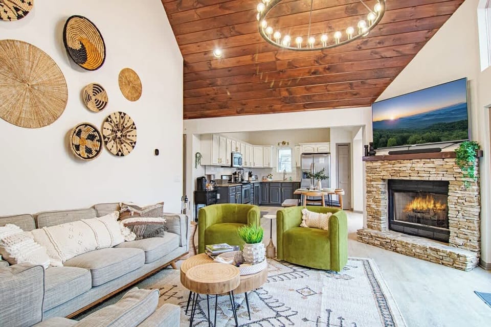 Bright living room w/ fireplace, plush seating & warm wood accents