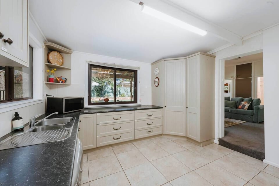 The thoughtfully equipped kitchen makes cooking a pleasure, featuring an oven, a dishwasher for easy clean-up, a Nespresso machine to start your mornings right, and a large bench for effortless meal prep.