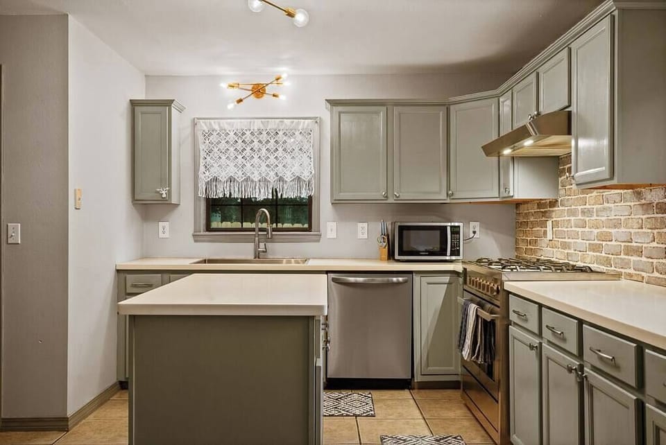 Clean kitchen w/ ample counter space & cabinetry for easy meal prep