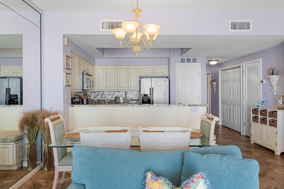 Open dining area w/ chandelier lighting & easy access to the kitchen.
