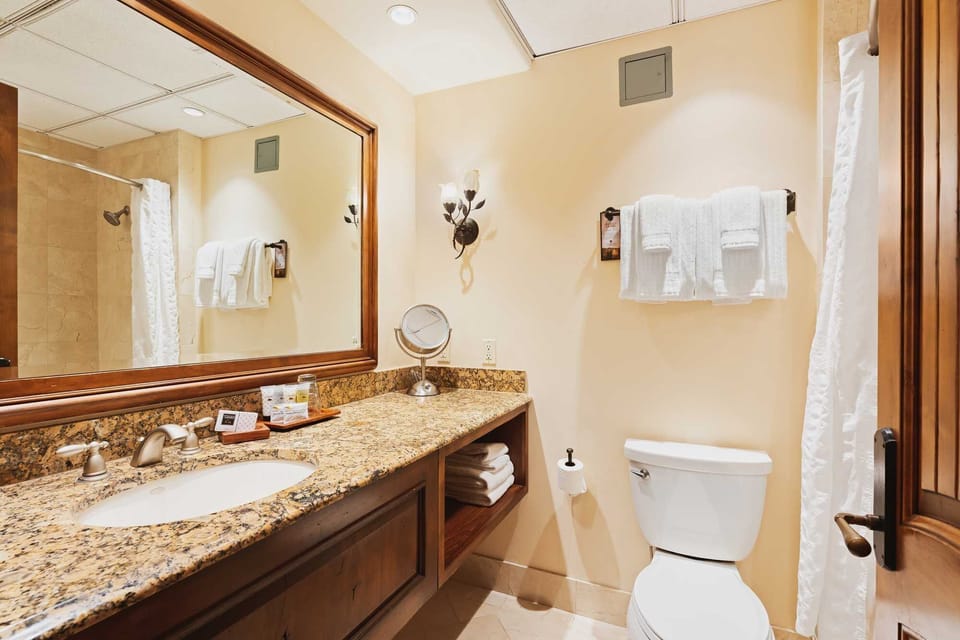 Freshen up at the granite vanity with bright, clean lighting.