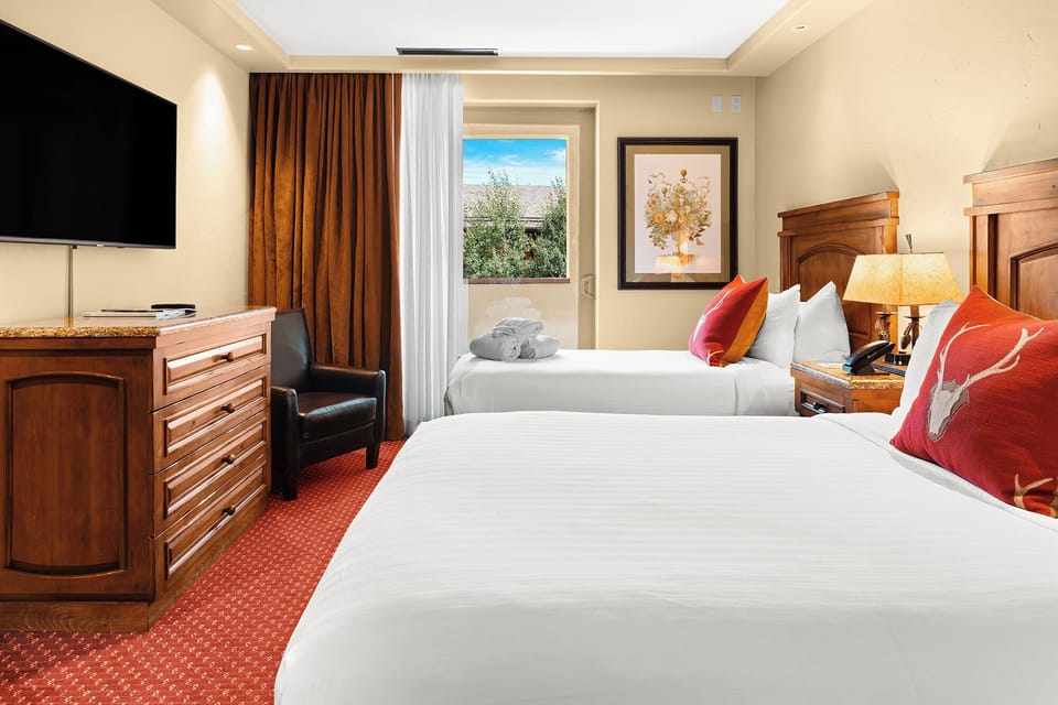 Sink into crisp beds under soft lighting after exploring.