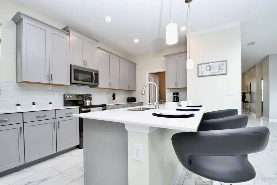 Fully equipped kitchen featuring sleek stainless steel appliances.