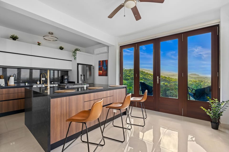 Modern kitchen with island and great views.