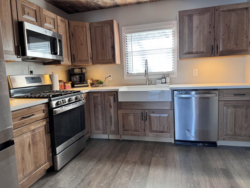 New appliances in kitchen w under cabinet lighting (coffee station rearranged)