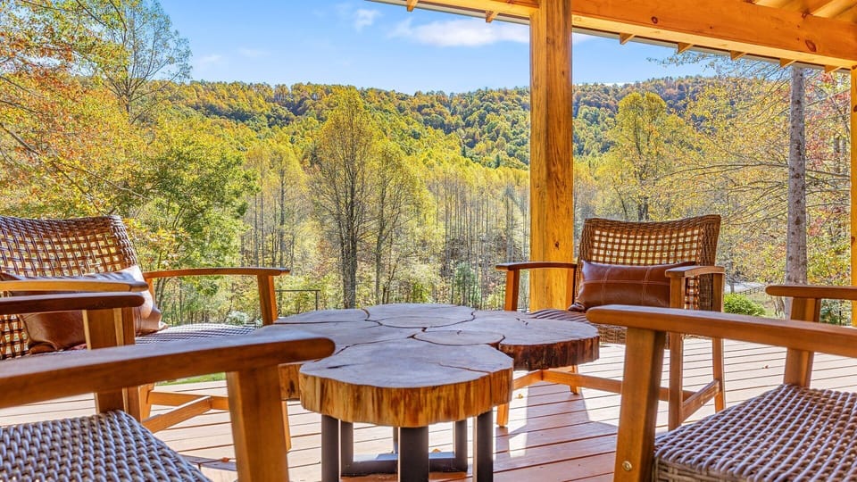 Open air covered wrap- around deck with dining area and swing