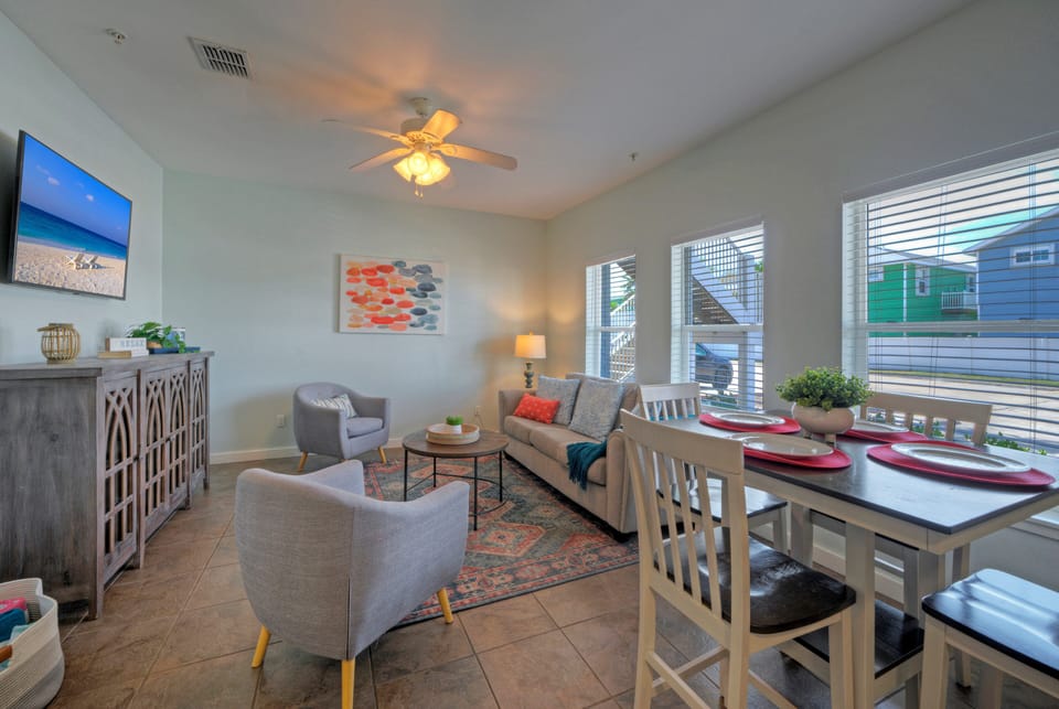The inviting living room boasts plush seating and a smart TV.
