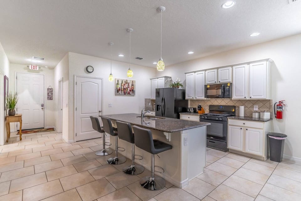 Upgraded and fully stocked kitchen with island seating for 4