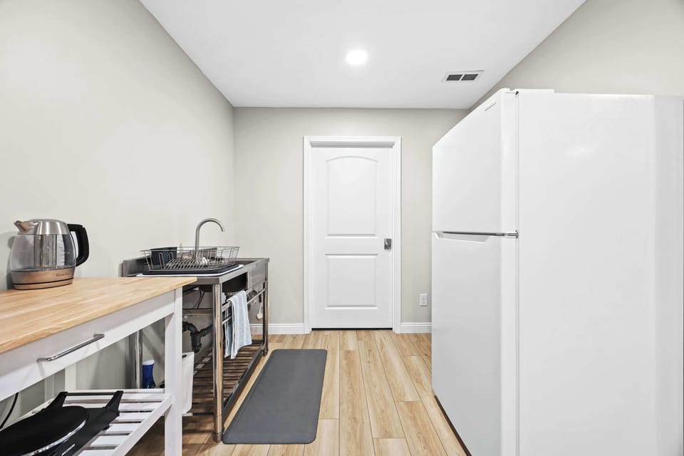 Kitchen: A bright, minimalist kitchen space with everything you need to cook, prep, and store your meals.