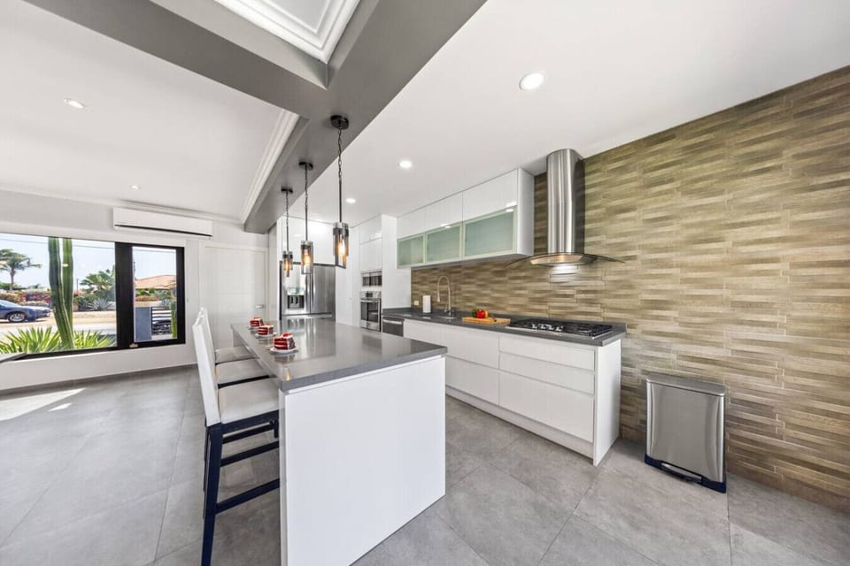 Modern kitchen with sleek finishes & island seating.