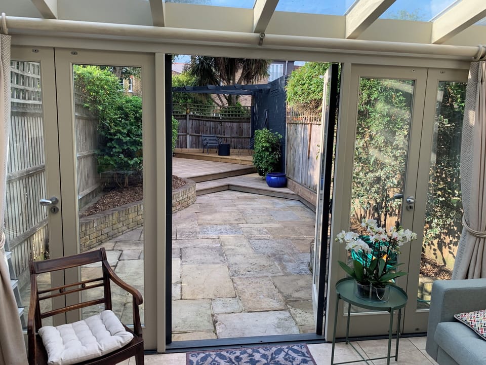 Paved back garden from the living room (there is a barbecue that can be used)