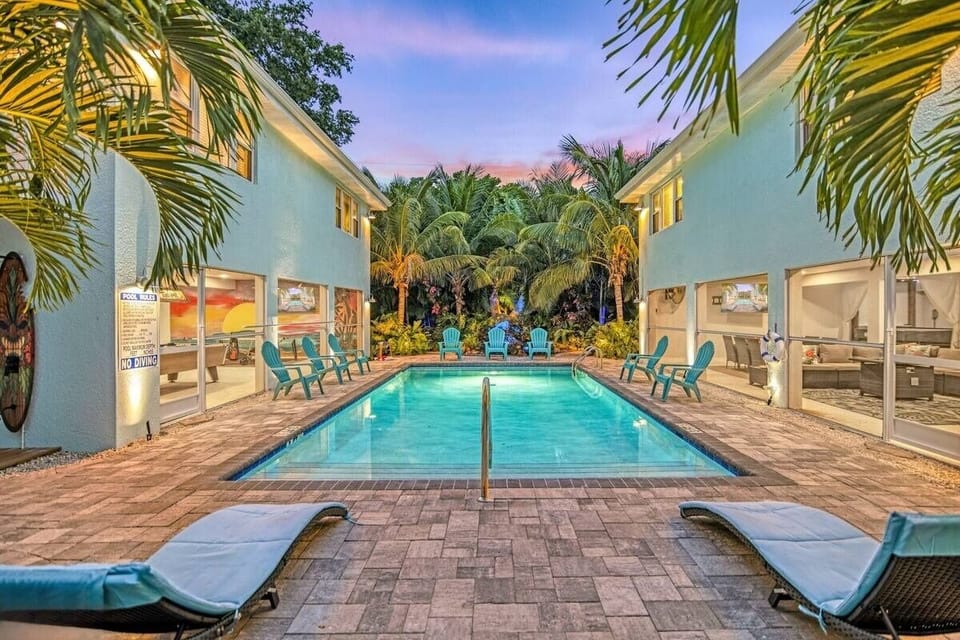 Outdoor Oasis: Dive into relaxation with a stunning pool surrounded by lush tropical greenery!