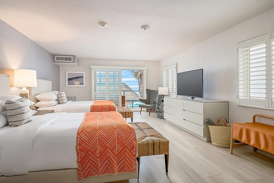 Recharge in crisp linens with sunlight pouring through shutters