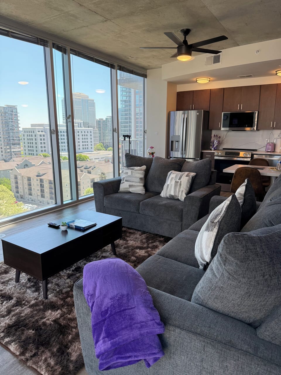 Take in breathtaking skyline views from this bright and modern living space featuring floor-to-ceiling windows, cozy seating, and an open-concept layout perfect for relaxing or entertaining in the heart of Midtown Atlanta.