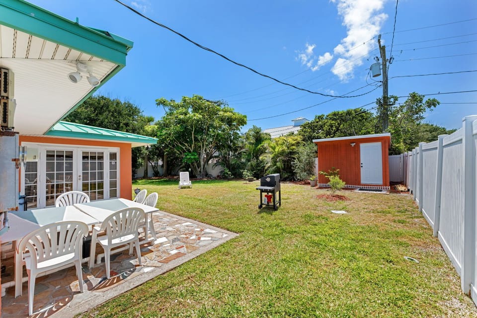 Spacious backyard with griller and dining area.