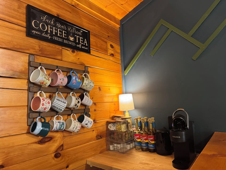 Coffee bar on main level with single serve Keurig, pods, flavor syrups, and tea