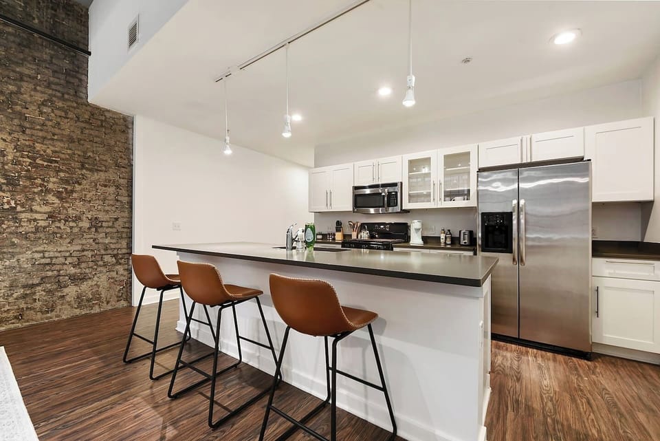 This sleek and stylish kitchen offers top-notch appliances and ample counter space for cooking.