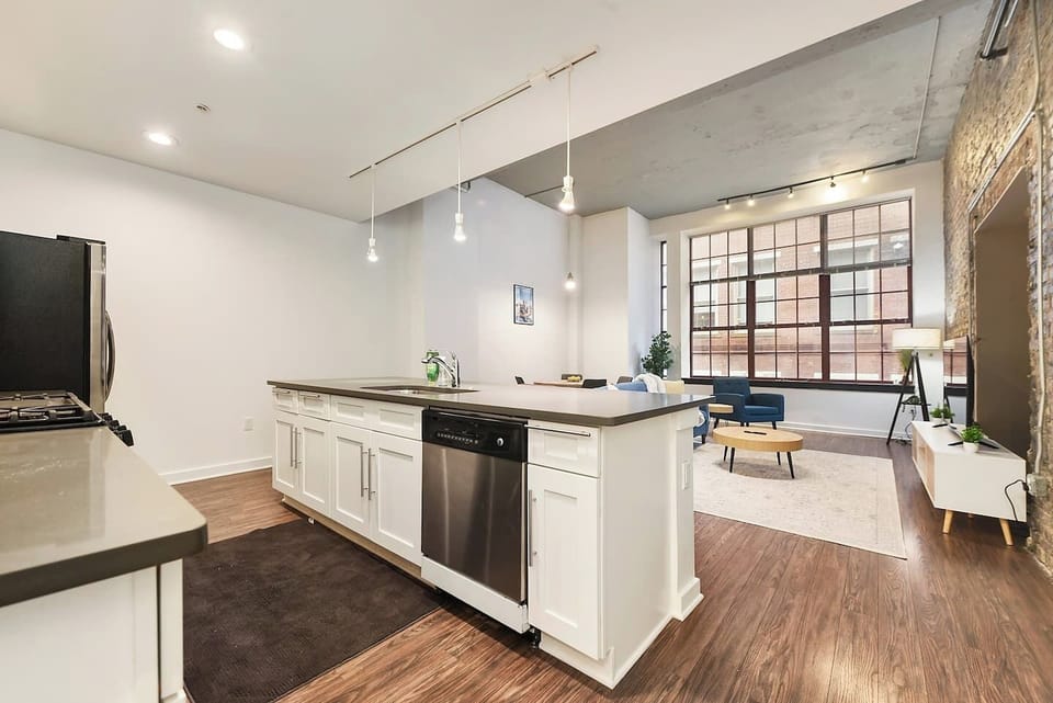 This sleek and stylish kitchen offers top-notch appliances and ample counter space for cooking.