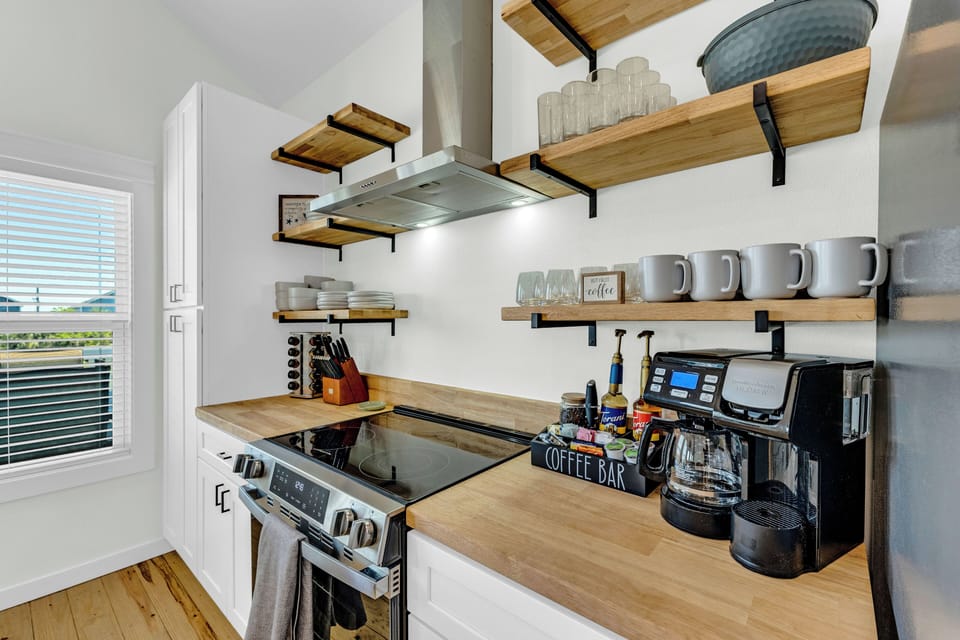 Coffee bar includes coffee grounds, k-cups, flavored syrups, and milk frother