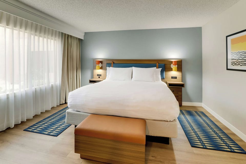 Drift off fast in a serene king bed with warm lighting.