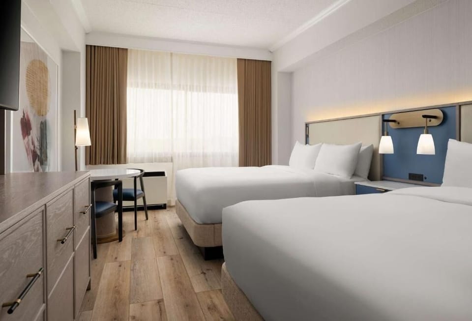 Drift off in bright double beds with hotel-fresh linens.