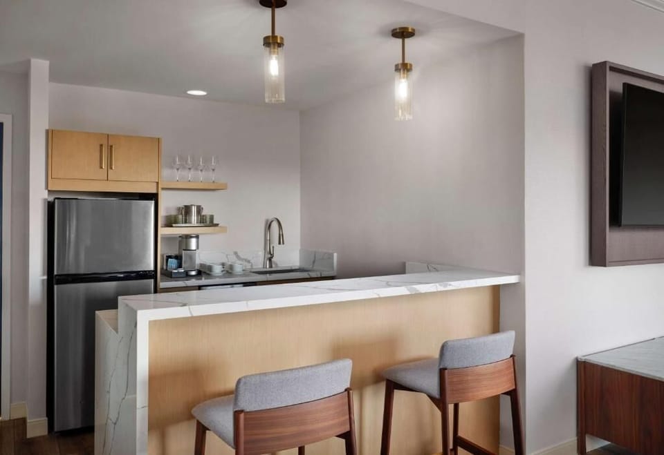 Enjoy easy snacks and drinks at the sleek bar kitchenette.
