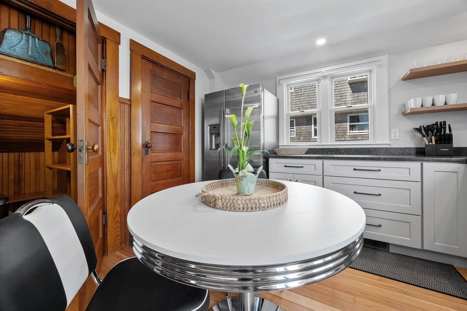 Kitchen with small cafe table and storage closet
