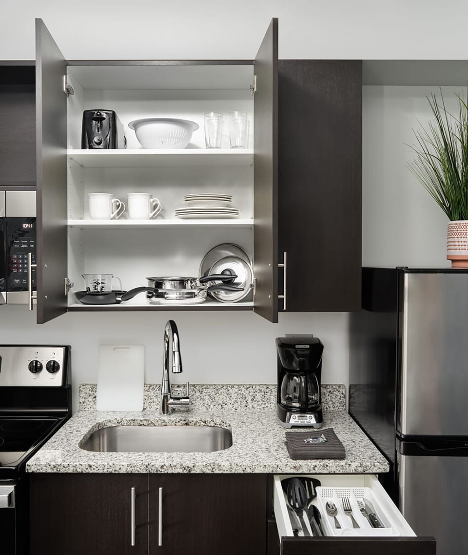 Feel at home with stocked dishes, cookware, and coffee essentials.