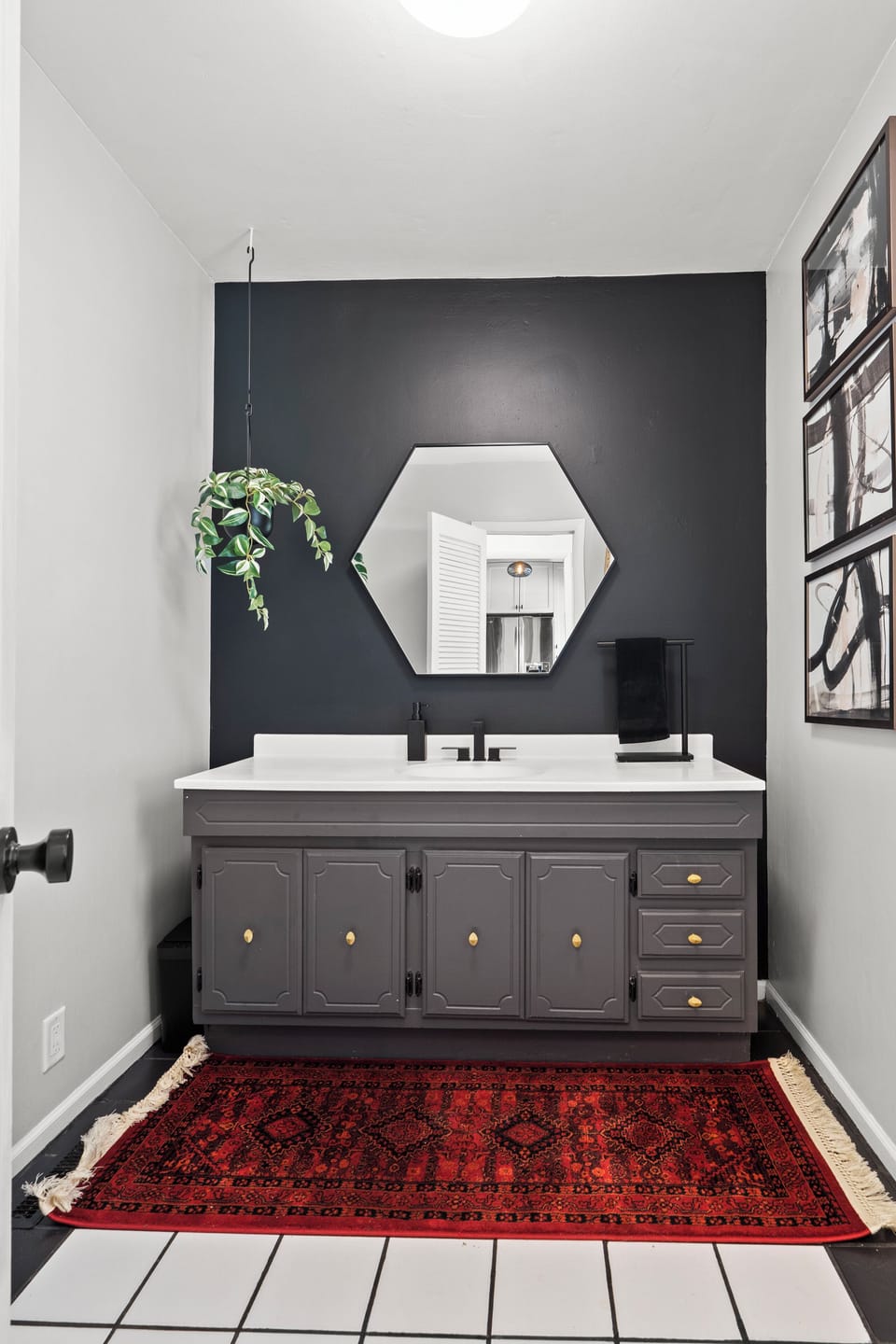 Stylish half bathroom with a bold accent wall, modern vanity, and great lighting