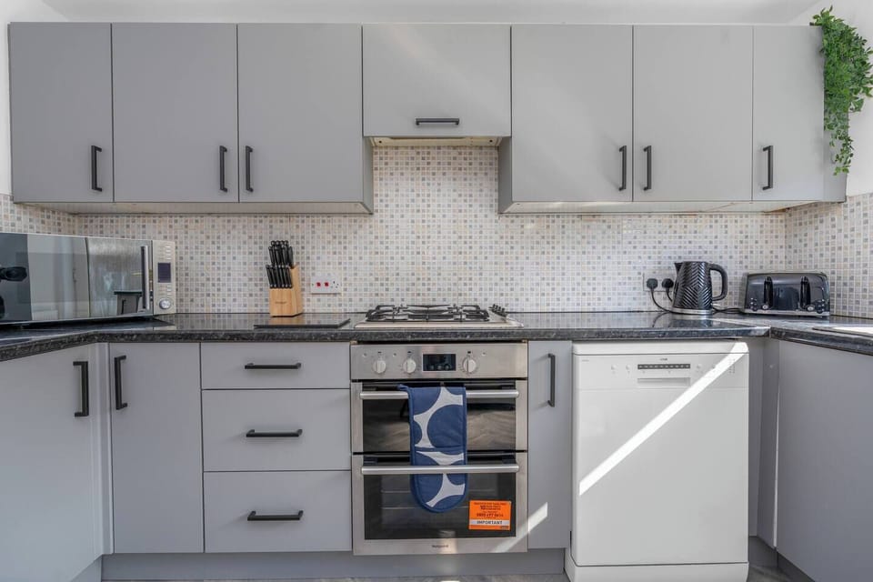 Fully equipped modern kitchen with sleek cabinetry, quality appliances, and everything you need for effortless home cooking.