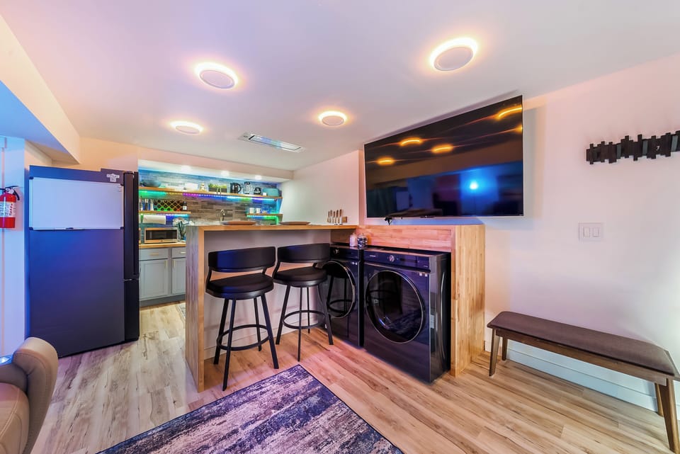 Your modern basement retreat features a full kitchen, breakfast bar, entertainment center, and convenient laundry facilities—perfect for extended stays.