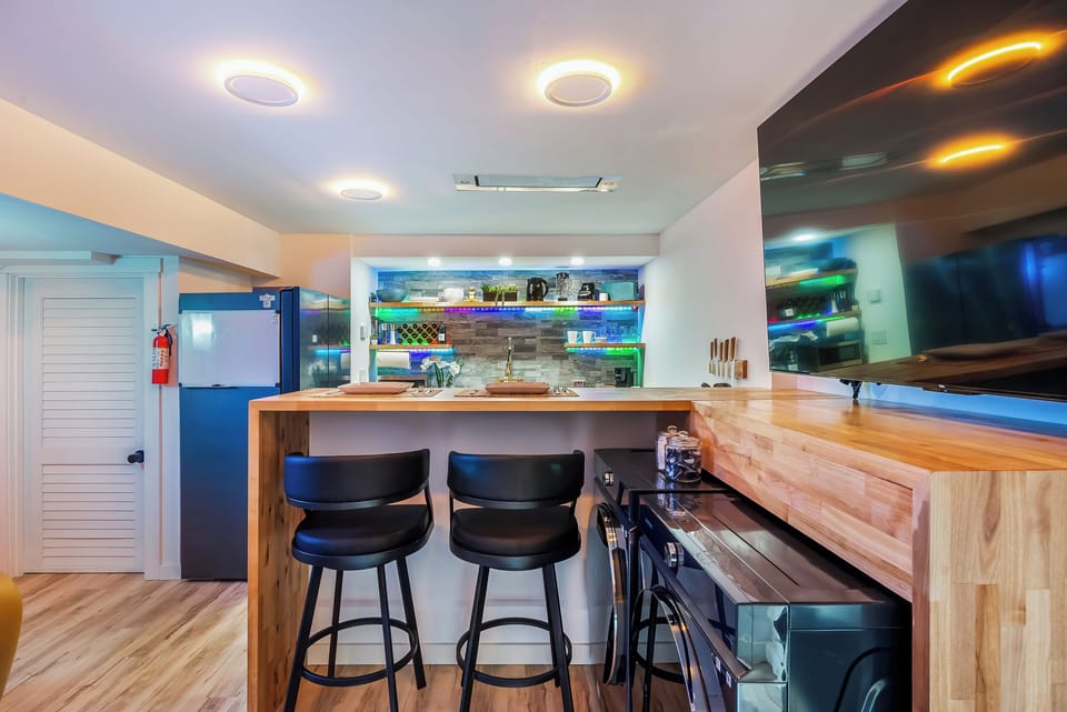 Enjoy your morning coffee at this stylish breakfast bar with modern amenities and warm wood finishes creating the perfect start to your day.