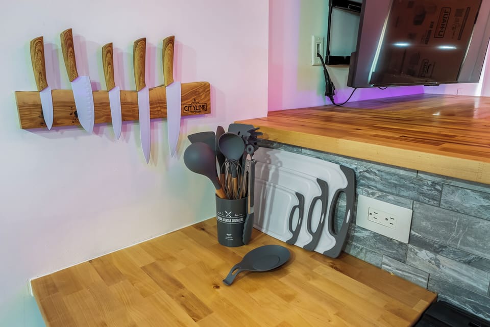 Your gourmet kitchen features professional-grade knives, quality cookware, and warm wood countertops—everything you need to create memorable meals.