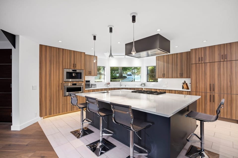 Sleek chef’s kitchen with expansive island seating—ideal for morning coffee, meal prep, or casual cocktails with a view.