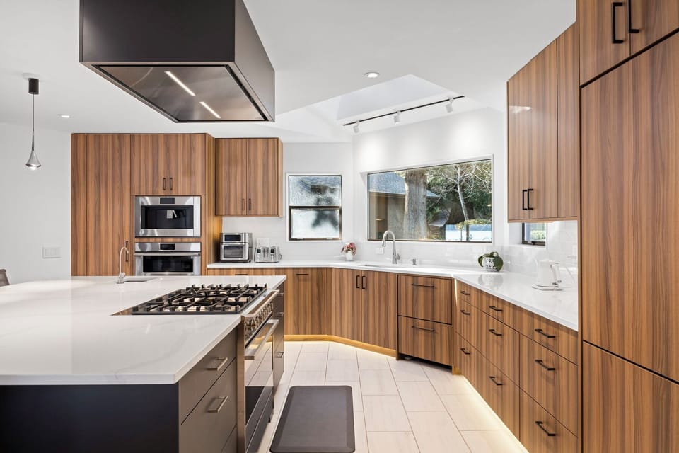Expansive kitchen with sleek island and gas range—your go-to spot for culinary creativity.