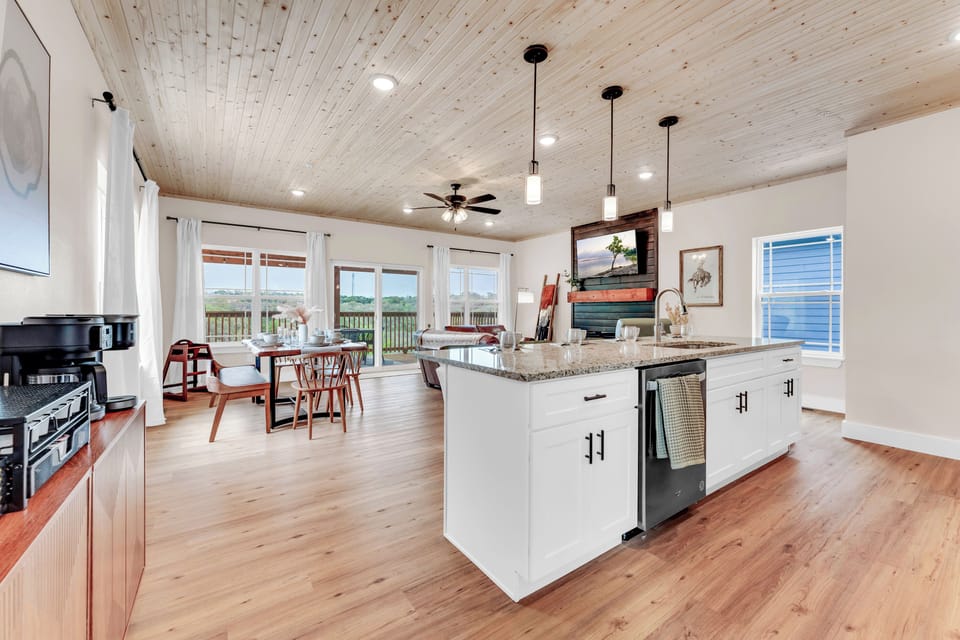 This open-concept space, where the modern kitchen and living room come together.