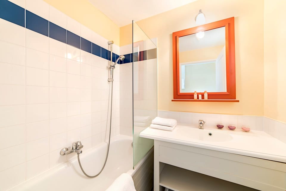 Get ready for the day in the modern and bright bathroom.