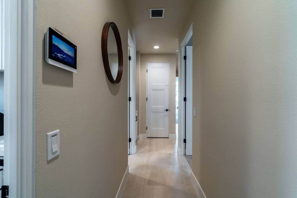 Bright hallway connecting bedrooms and living spaces.