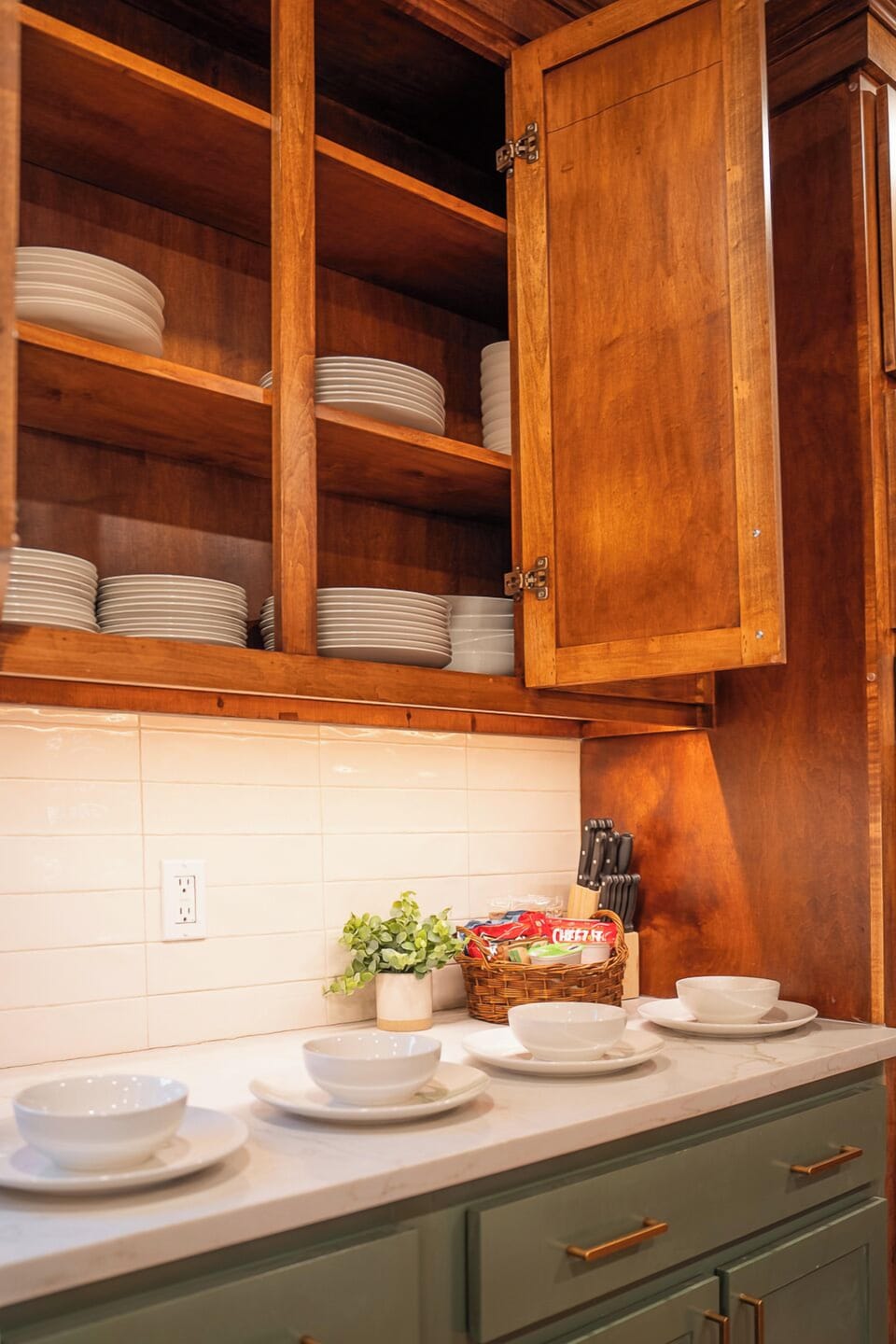 Fully stocked kitchen with neatly organized dinnerware and essentials, ready for a comfortable and convenient stay.