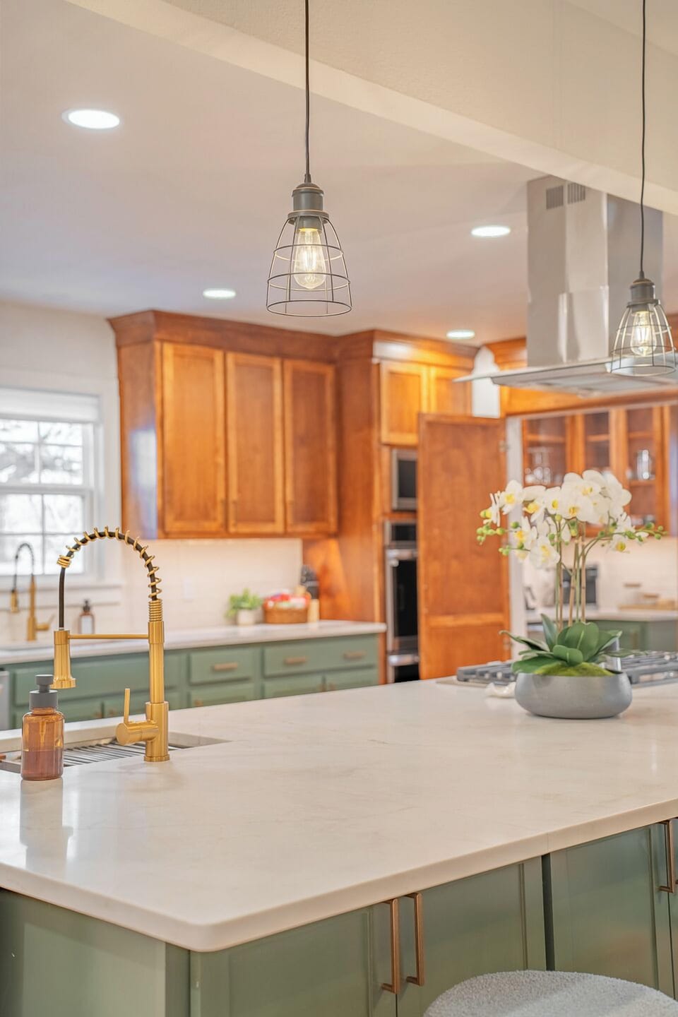 Spacious and elegant kitchen featuring modern fixtures, a large island, and warm wood cabinetry for a perfect blend of style and function.