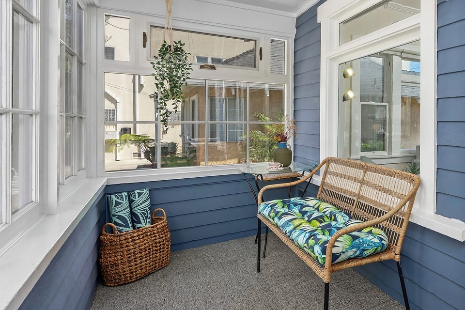 Cozy and bright sunroom with comfortable seating.