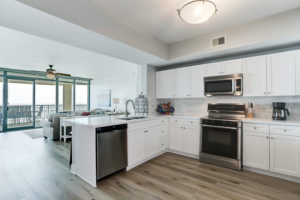 Fully equipped kitchen with stainless steel appliances and Gulf views — cook and relax in your Galveston beach condo!