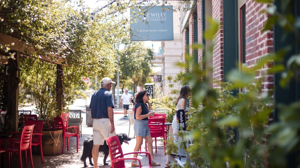 Visitors strolling through Galveston's Historic Downtown near Post Office Street, exploring shops, galleries, and local charm.