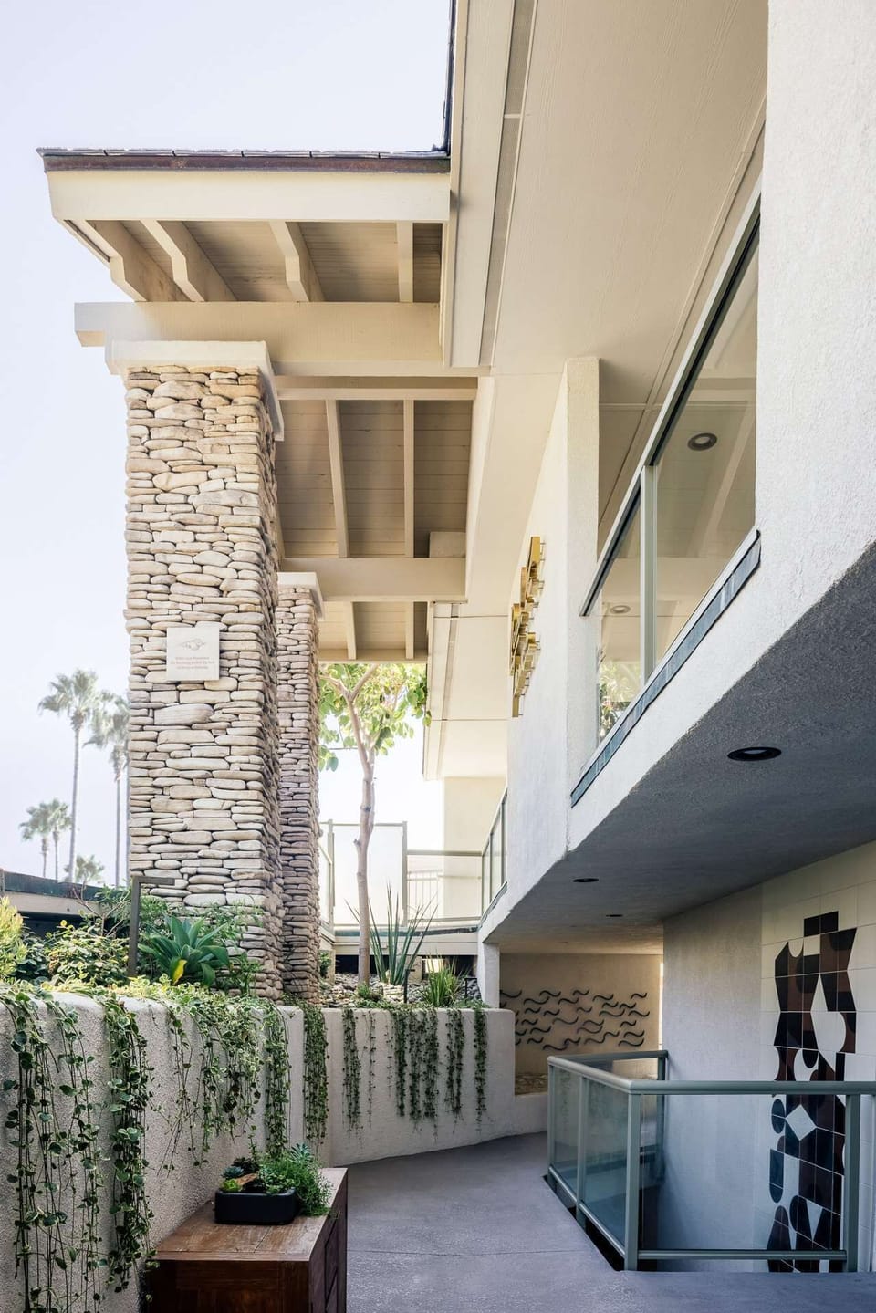 Stroll through the serene courtyard with modern coastal design