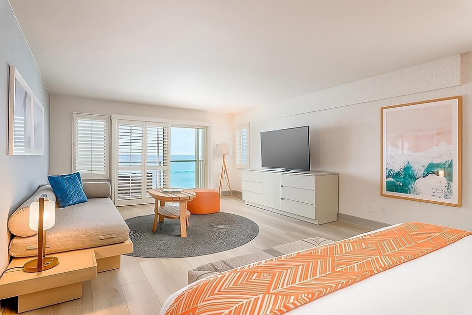 Unwind on the sofa while waves shimmer beyond the balcony