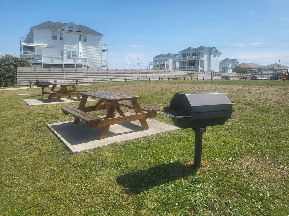 Grills and picnic tables waiting on you to come enjoy a meal and sound view :)